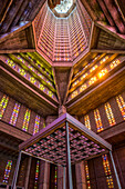 Interior of St. Joseph’s Church in Le Havre, showcasing Auguste Perret’s modernist design with vibrant stained glass.