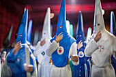 Close up of Nazarenos figures displayed in a Holy Week object shop in Seville, Spain, showcasing traditional Spanish Easter procession attire.