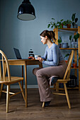 Woman using laptop at home