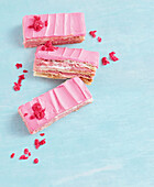 Fluffy raspberry and vanilla slices with pink frosting