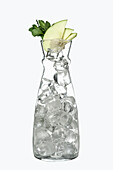 Carafe with ice cubes, apple slices and mint