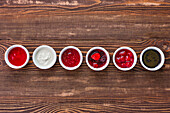 Various berry jams and fruit purees in bowls