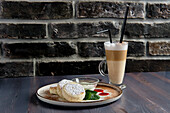 Syrniki (cream cheese pancakes) with sour cream and latte macchiato