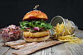 Fish burger with chips and salad