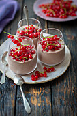 Yoghurt and cocoa dessert with redcurrants