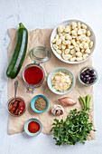 Ingredients for gnocchi with tomato sauce, zucchinis and olives