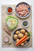 Ingredients for potato and cabbage stew with carrots and chicken