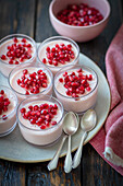 Strawberry and yogurt dessert with pomegranate seeds