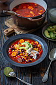 Mexican soup with chorizo, beans, sweetcorn and avocado