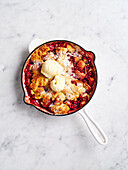 Apple and pomegranate cobbler with vanilla ice cream