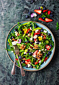 Green asparagus salad with berries, feta cheese and walnuts