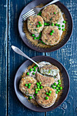 Fish cakes with peas and cream sauce