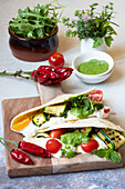 Piadina with buffalo stracciata, courgette, tomatoes and pesto