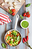 Gnocchi with rocket pesto and cherry tomatoes