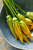 Courgette flowers in a ceramic bowl