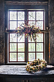 Rustic wooden window with dried flowers and wreath of dried flowers, country style