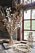 Dried flower arrangement on a rustic windowsill