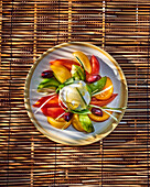 Colourful caprese salad with mozzarella and olives