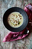 Cheese soup with croutons, bacon and chive oil