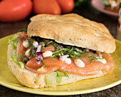 Ciabatta sandwich with smoked salmon and vegetables