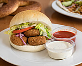 Falafel sandwich with salad and dips