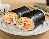 Sushi burrito with salmon, surimi and vegetables