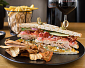 Club sandwich with chicken, bacon and fries