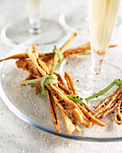 Puff pastry grissini with curry and sesame seeds