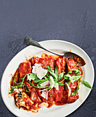 Spinach and ricotta cannelloni with tomato sauce and rocket