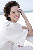 Brunette woman in cream-coloured blouse