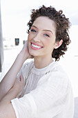 Brunette woman in cream-coloured blouse