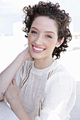 Brunette woman in cream-coloured blouse