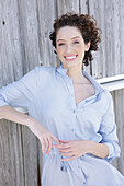 Young woman in light-blue shirt dress