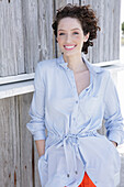 Young woman in light-blue shirt dress