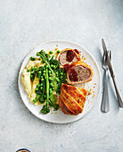 Rissoles wrapped in pastry with peas, broccolini and mashed potatoes