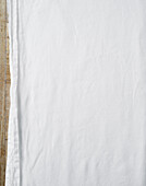 White tablecloth on wooden table - background