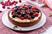 Berry tart with vanilla cream and pistachios