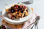 Marble waffles with fresh cherries and chocolate sauce