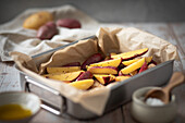 Preparing jacket potatoes with spices and olive oil