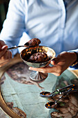 Chocolate ice cream in a silver bowl