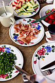 Breakfast table with ham, fruit and vegetables