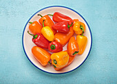 Colourful mini peppers on a white plate