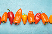 Various colourful peppers in a row