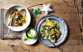 Grilled fish fillet with olives and tomatoes and courgette squash salad