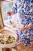 Potato salad with fresh herbs with roast ham