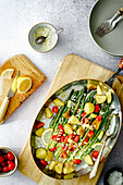 Potato and asparagus pan with cherry tomatoes and lemon