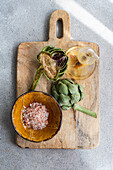 Sliced artichoke with coarse sea salt and olive oil