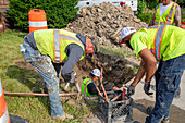 Workers replacing lead water pipes