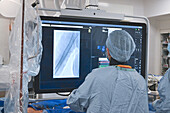 Doctors observing live X-ray during TAVI procedure