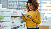 Woman choosing medication in pharmacy